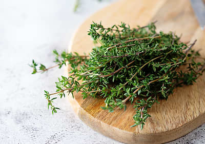 Thymianzweige auf einem Holzbrett