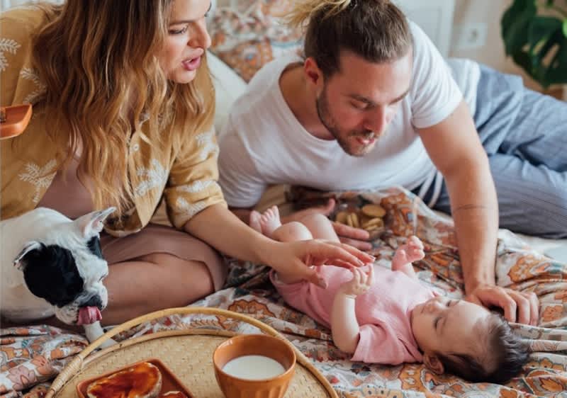 Mutter und Vater spielen mit Baby