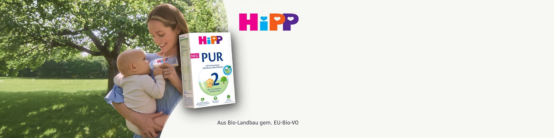 Eine Packung Bio-Folgemilch von HiPP mit der Aufschrift „PUR“ und „Bio-Folgemilch nach dem 6. Monat“. Links oben steht „NEU“, daneben das HiPP-Logo in bunten Buchstaben.