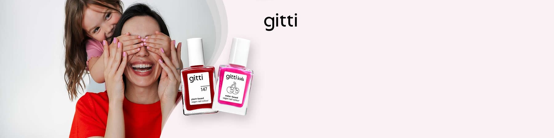Zwei Nagellackflaschen von gitti auf hellem Hintergrund, links rot mit der Aufschrift „plant-based vegan nail colour 147“, rechts pink mit der Aufschrift „gitti kids water-based vegan nail colour“ und einem Kirschmotiv