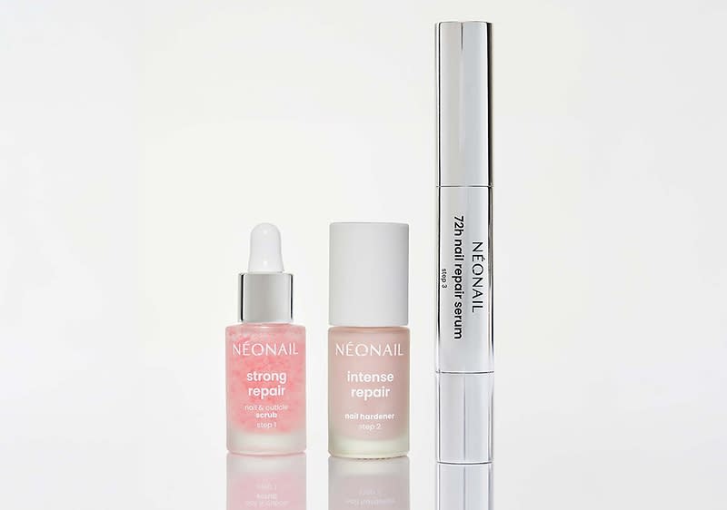 Drei Nagelpflegeprodukte von NEONAIL nebeneinander auf hellem Hintergrund: links kleines rosa Serumfläschchen mit Pipette und Aufschrift „NEONAIL strong repair“, in der Mitte mattweiße Flasche mit Aufschrift „NEONAIL intense repair soft hardener“, rechts silberner Stift mit Aufschrift „NEONAIL 2in1 nail repair serum“