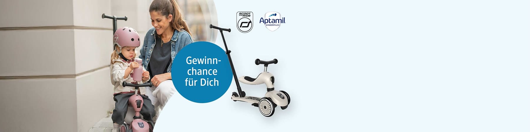 Dreirädriges, cremeweißes Kinderlaufrad mit schwarzem Lenker und Schiebstange, rechts oben das Aptamil-Logo und links ein blauer Kreis mit dem Text „Gewinnchance für Dich“