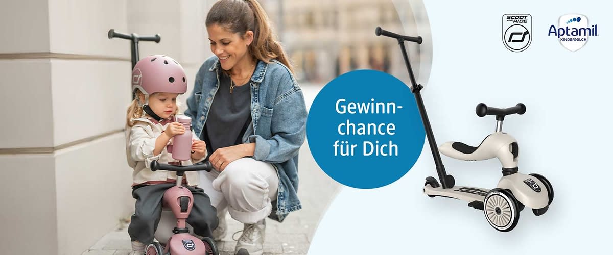 Zwei Kinder sitzen nebeneinander, das vordere Kind trägt einen rosa Helm und sitzt auf einem rosa Dreirad, das hintere Kind hält die Schiebe- und Lenkerstange eines cremefarbenen Kinder-Laufrollers mit schwarzem Griff; blauer Kreis mit weißer Schrift „Gewinnchance für Dich“ sowie oben rechts das Aptamil-Logo und ein kleines Scoot & Ride-Logo