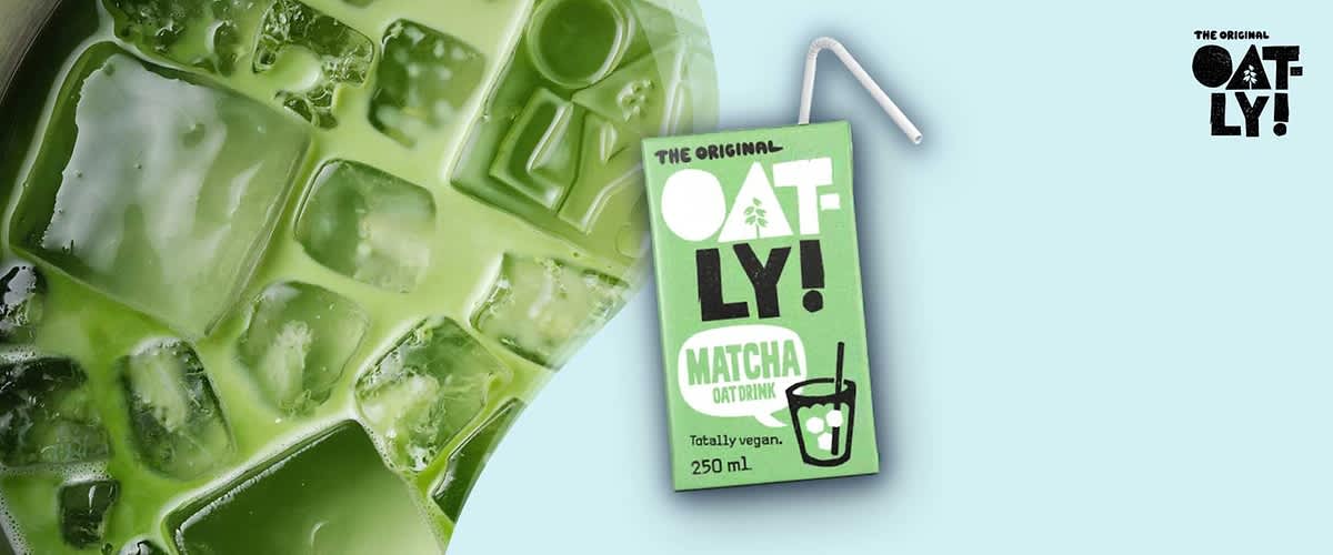 Hellgrüne Oatly Matcha Haferdrink-Tetra Pak mit aufgestecktem Trinkhalm, vorne Aufschrift „THE ORIGINAL OAT-LY! MATCHA OAT DRINK Totally vegan. 250 ml“ und kleines Glas-Icon, vor türkisfarbenem Hintergrund ohne Punkt am Satzende