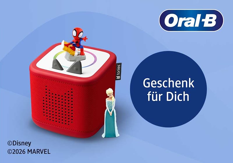 Rotes Tonie-ähnliches Spielwürfel-Gerät mit einer Spider-Man-Figur obenauf und einer Elsa-Figur seitlich, neben dunkelblauem Kreis mit weißer Schrift „Geschenk für Dich“ und Oral‑B Logo oben rechts