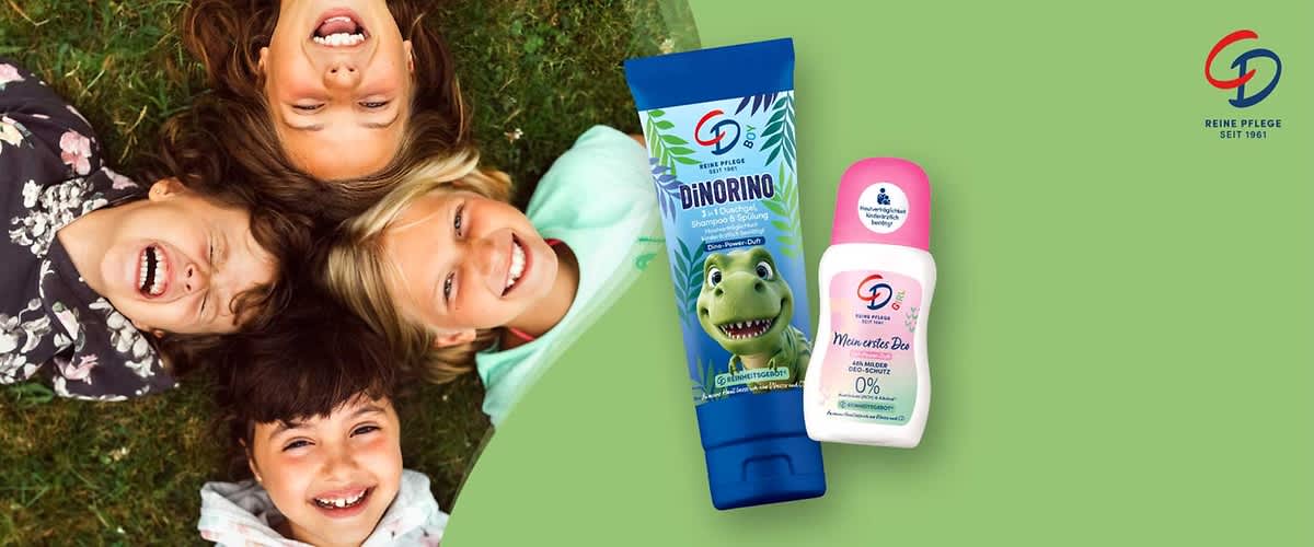 zwei Kinderpflegeprodukte der Marke CD auf hellgrünem Hintergrund: links eine blaue Tube mit Dino-Illustration und Aufschrift „DiNORINO 3 in 1 Duschgel, Shampoo & Spülung“, rechts ein weißer Deo-Roller mit rosa Kappe und Aufschrift „Mein erstes Deo 48h milder Deo-Schutz 0% Aluminium & Alkohol“ und Markenlogo