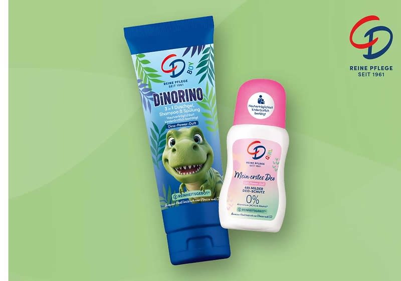 zwei Kinderpflegeprodukte der Marke CD auf hellgrünem Hintergrund: links eine blaue Tube mit Dino-Illustration und Aufschrift „DiNORINO 3 in 1 Duschgel, Shampoo & Spülung“, rechts ein weißer Deo-Roller mit rosa Kappe und Aufschrift „Mein erstes Deo 48h milder Deo-Schutz 0% Aluminium & Alkohol“ und Markenlogo