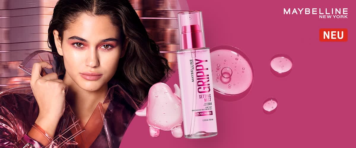 Maybelline Setting Mist „GriPPY“ in transparenter Pumpsprühflasche mit rosa Flüssigkeit, Markenname Maybelline New York oben rechts und rotes Etikett „NEU“