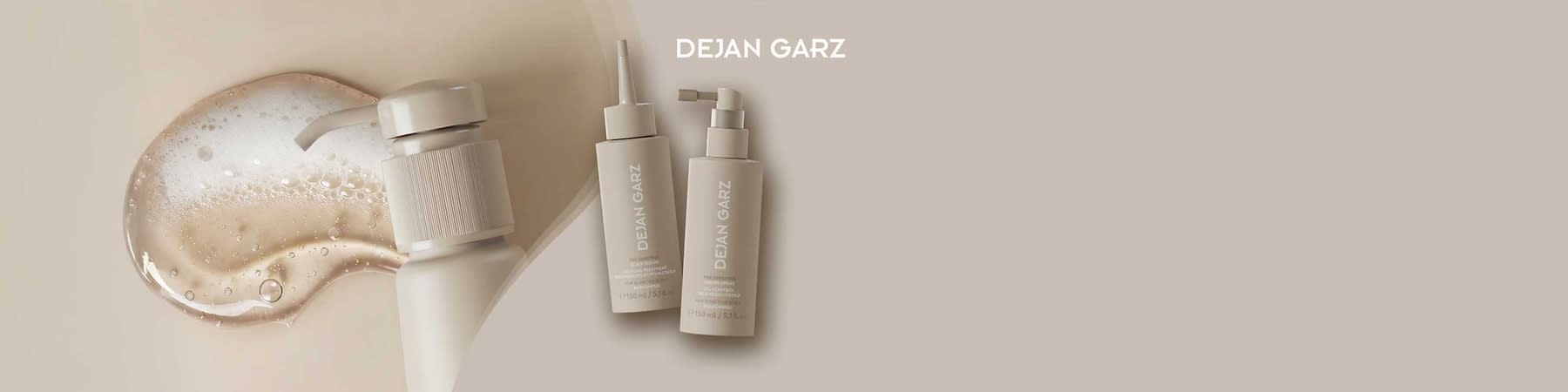 Zwei beige Plastikflaschen der Marke DEJAN GARZ mit Aufschrift, links mit schmaler Spitze, rechts mit Pumpspender, jeweils 150 ml, vor hellem beigem Hintergrund