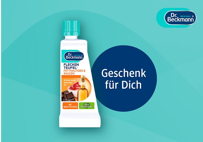 Dr. Beckmann Fleckenteufel Spezialreiniger für fettige & saucenartige Flecken in weißer Tube mit grünem Verschluss, Aufschrift „Geschenk für Dich“ auf blauem Kreis
