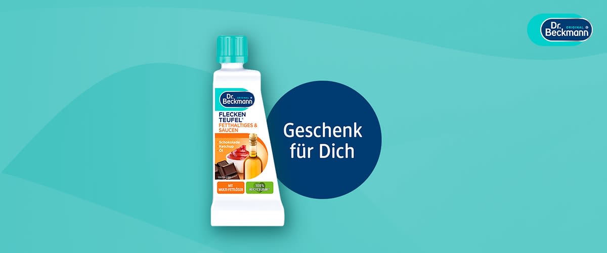 Dr. Beckmann Fleckenteufel Spezialreiniger für fettige & saucenartige Flecken in weißer Tube mit grünem Verschluss, Aufschrift „Geschenk für Dich“ auf blauem Kreis