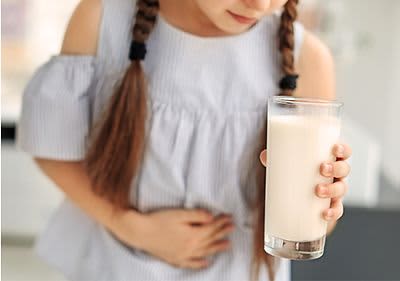 Kind hält sich die Hand vor den schmerzenden Bauch