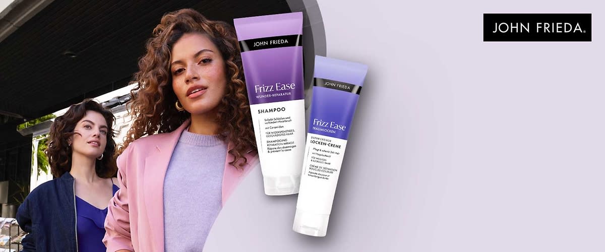 Zwei Produktverpackungen von John Frieda. Links eine lila Tube mit der Aufschrift „Frizz Ease Wunder Reparatur Shampoo“. Rechts eine kleinere lila Tube mit der Aufschrift „Frizz Ease Wunder Reparatur Locken Creme“. Oben rechts das Logo von John Frieda
