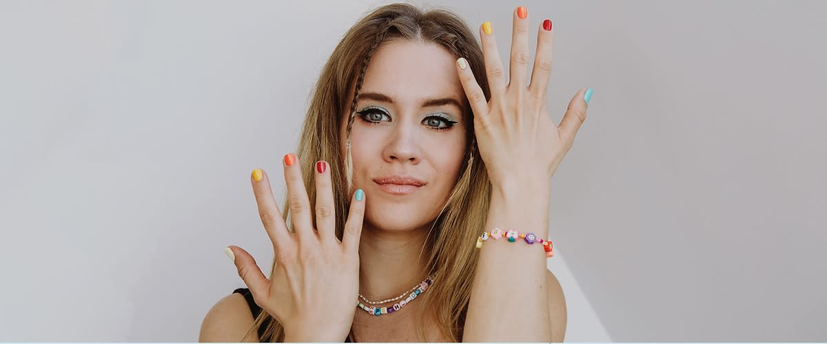 Djevojka s festivalskim make up-om i šareno nalakiranim noktima