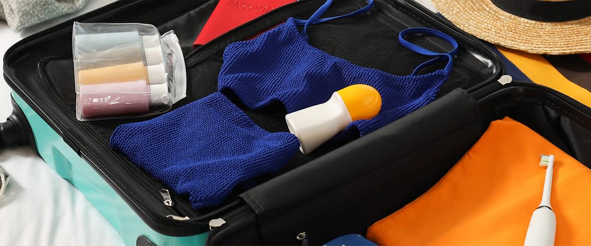 kofer u kojem su plavi badić i dezodorans na vrhu