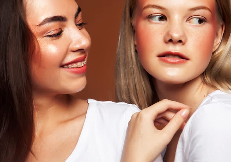 dvije mlade djevojke poziraju pred kamerom