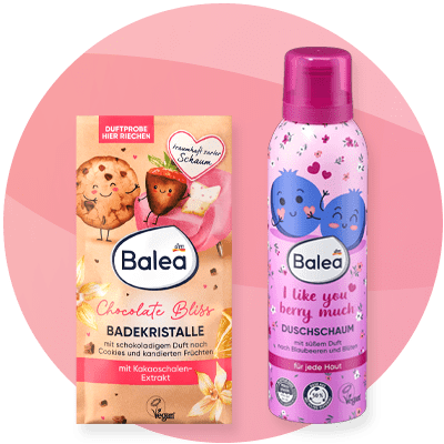 Prodotti Balea con bagnoschiuma e cristalli da bagno su sfondo rosa sfumato