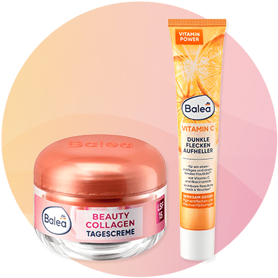 Crema giorno al collagene e siero alla vitamina C Balea su sfondo rosa sfumato