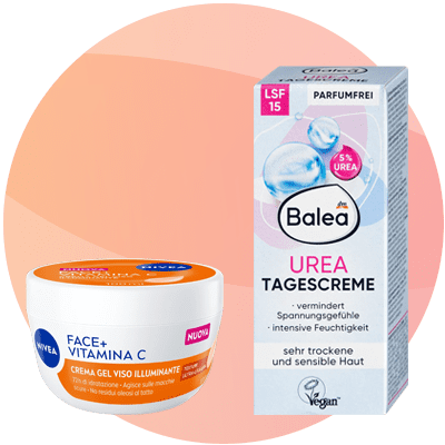 A vasetto bianco e arancione di crema viso Nivea Face+ Vitamina C con etichetta Crema gel viso illuminante accanto a una scatola grigia e rosa di Balea Urea Tagescreme con eticheza Parfumfrei, 5% Urea e indicazione per pelle molto secca e sensibile