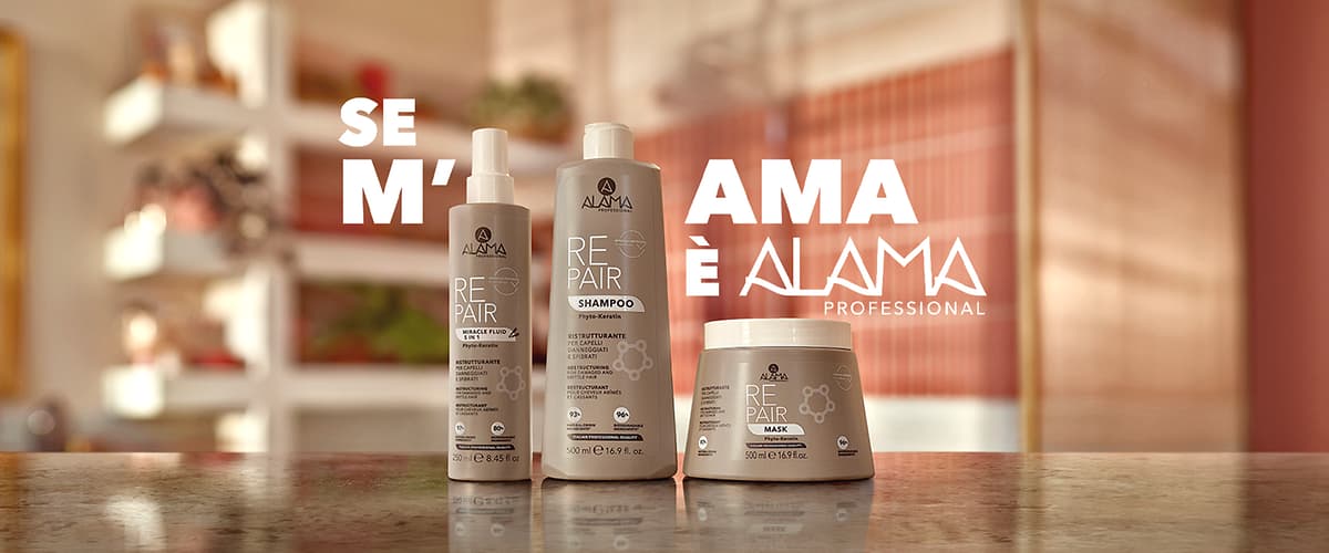 Prodotti per capelli Alama Repair su tavolo con sfondo sfocato con slogan Se m'ama è Alama Professional