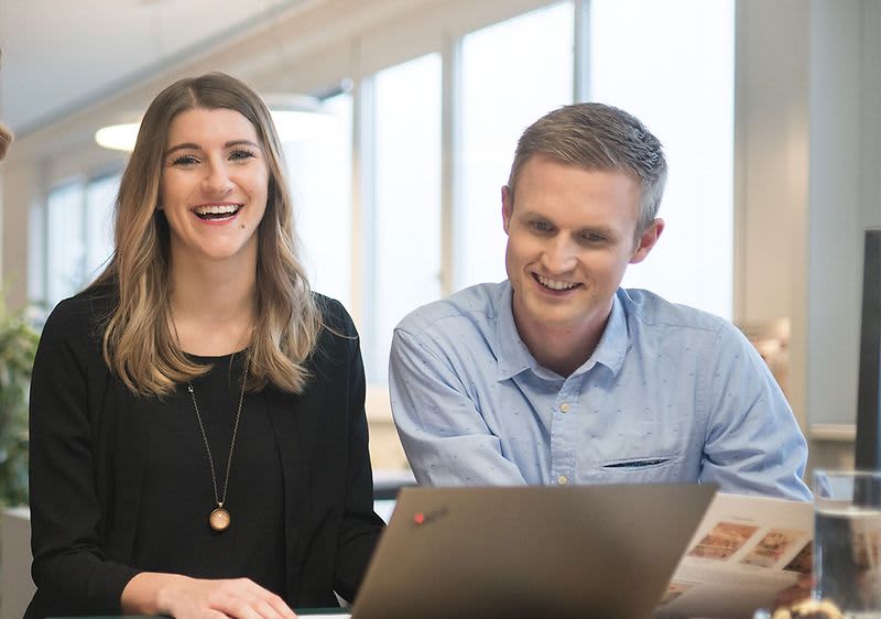Uomo e donna sorridenti davanti al pc