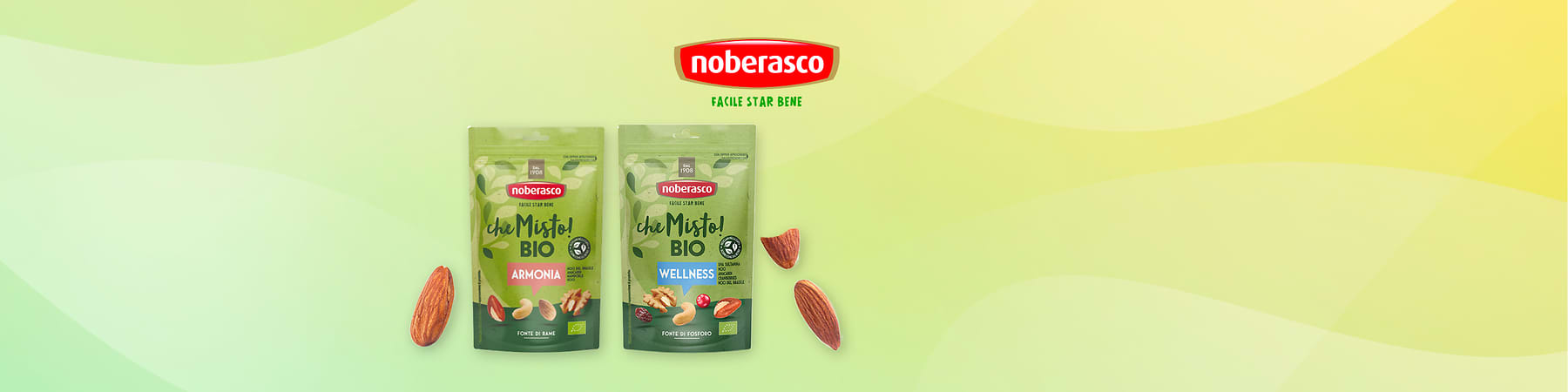 Snack Noberasco bio con mandorle e confezioni Armonia e Wellness su sfondo verde con mandorle