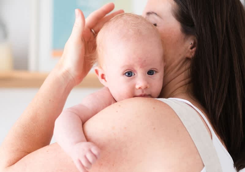 bebè appoggiato sulla spalla della mamma