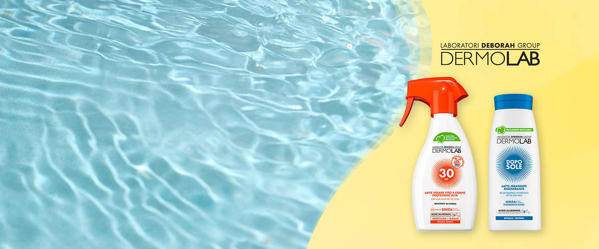Dermolab spray solare SPF30 e doposole su sfondo giallo con acqua riflettente