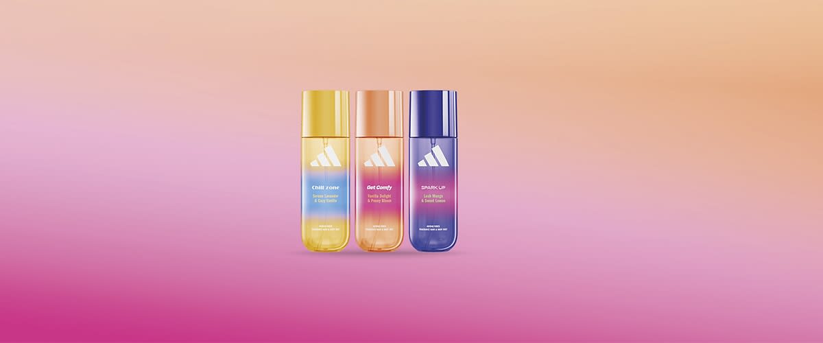 Profumi Adidas colorati su sfondo sfumato rosa e arancione