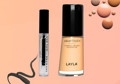 Fondotinta e gel per sopraccigliaLAYLA Cosmetics su sfondo arancione con cerchi decorativi