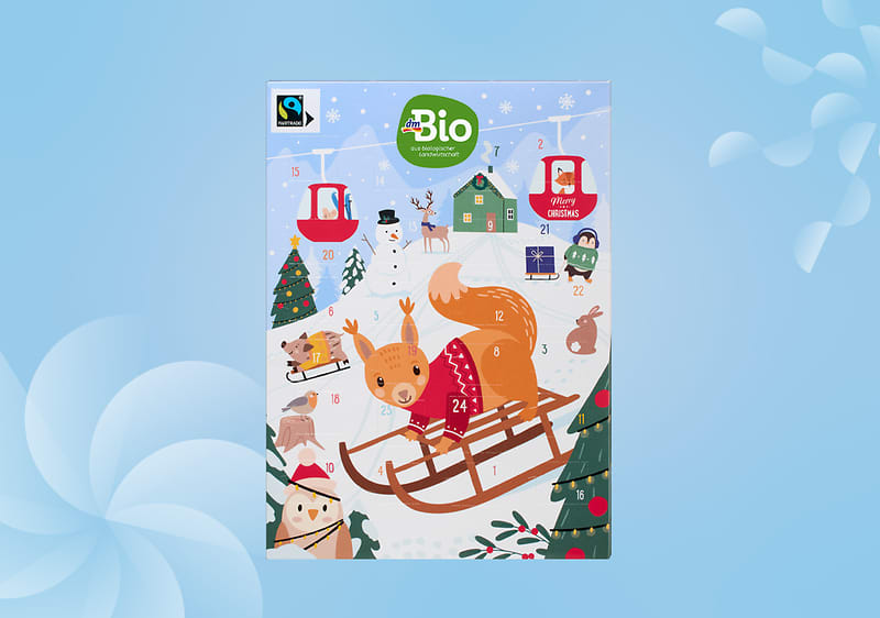 Calendario dell'avvento cioccolata dmBio con scoiattolo su slitta e scene natalizie