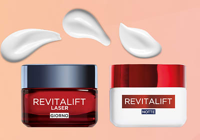 Crema viso Revitalift giorno e notte con texture crema bianca su sfondo sfumato
