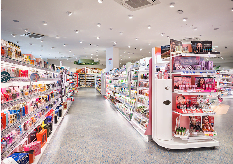 Interno di un punto vendita dm con scaffali pieni di cosmetici e prodotti di bellezza