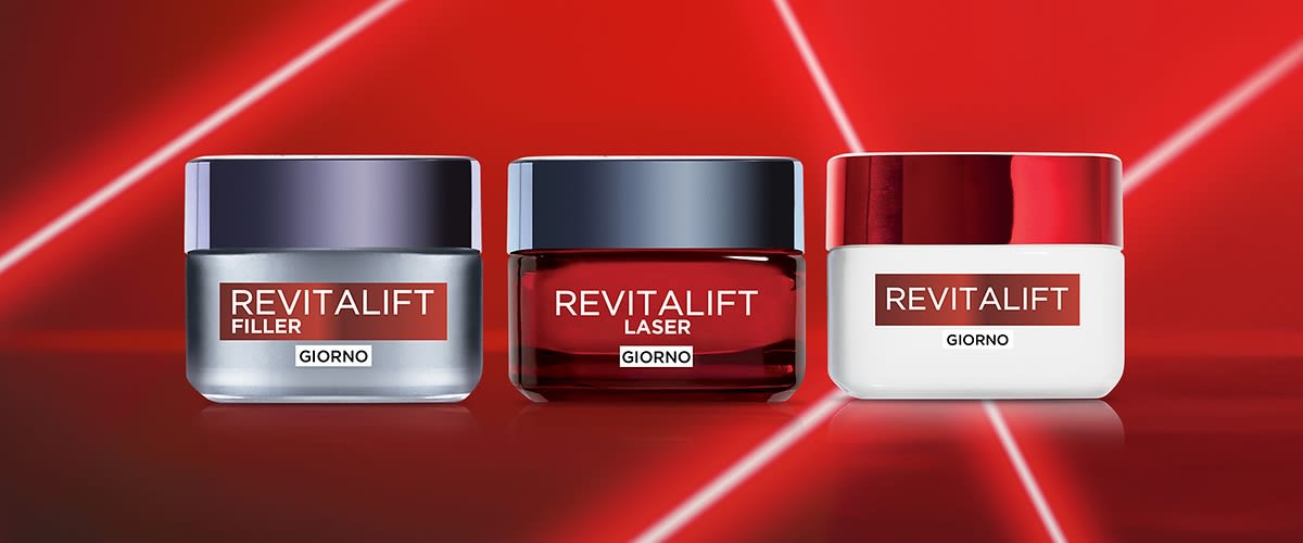 Creme Revitalift su sfondo rosso con linee luminose