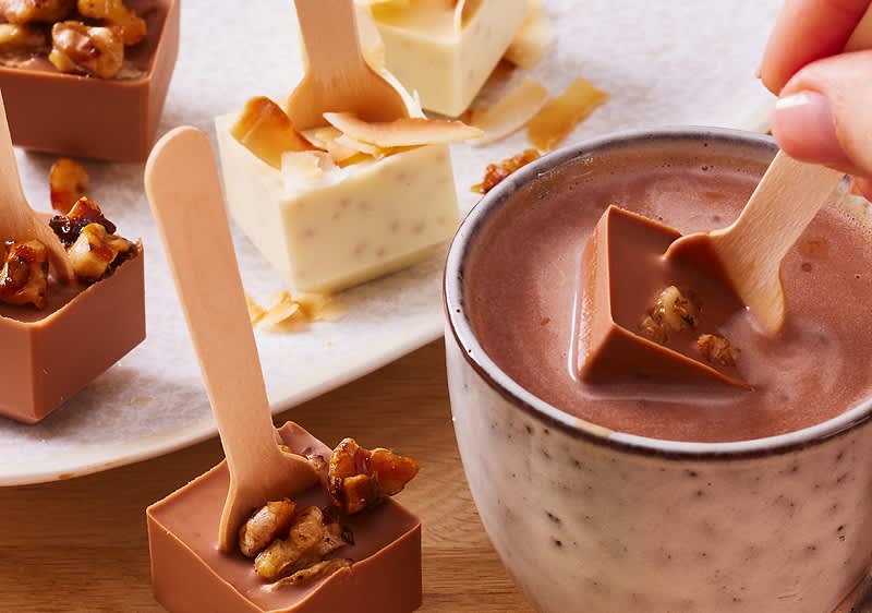 Cioccolata calda con cubetti di cioccolato e cucchiai di legno