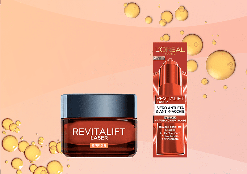 Barattolo marrone trasparente con coperchio grigio e scritta bianca REVITALIFT LASER SPF 25 a sinistra e confezione verticale rossa a destra con logo L'Oréal Paris e testo REVITALIFT LASER SIERO ANTI-ETÀ & ANTI-MACCHIE su sfondo rosa con bolle dorate