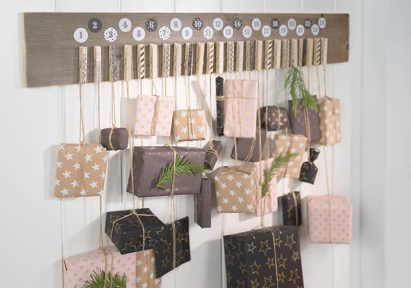 Adventskalender mit verzierten Holzklammern