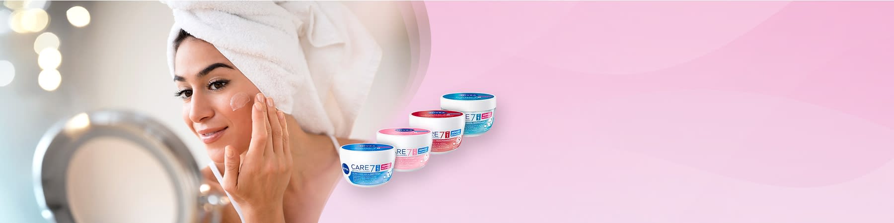 Kobieta z ręcznikiem na głowie nakłada krem, obok słoiczki kremu NIVEA CARE7 w różnych wariantach.