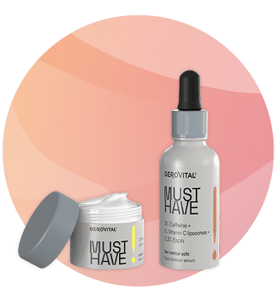 Un borcan de cremă deschis cu capac gri alături de o sticlă cu pipetă albă și etichetă „GEROVITAL MUST HAVE”, ambele produse de îngrijire, pe fundal circular degradé roz-oranj, pe etichetă mențiuni mici despre ingrediente și tipul produselor