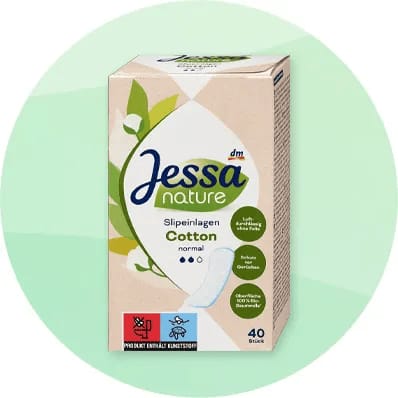 Cutie de absorbante Jessa Nature Cotton pe fundal verde.