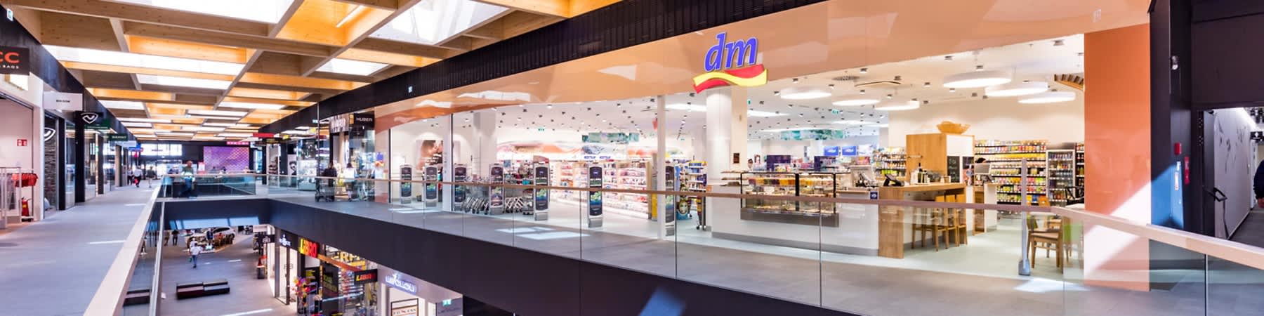 Interiorul unui centru comercial modern cu magazine și lumină naturală