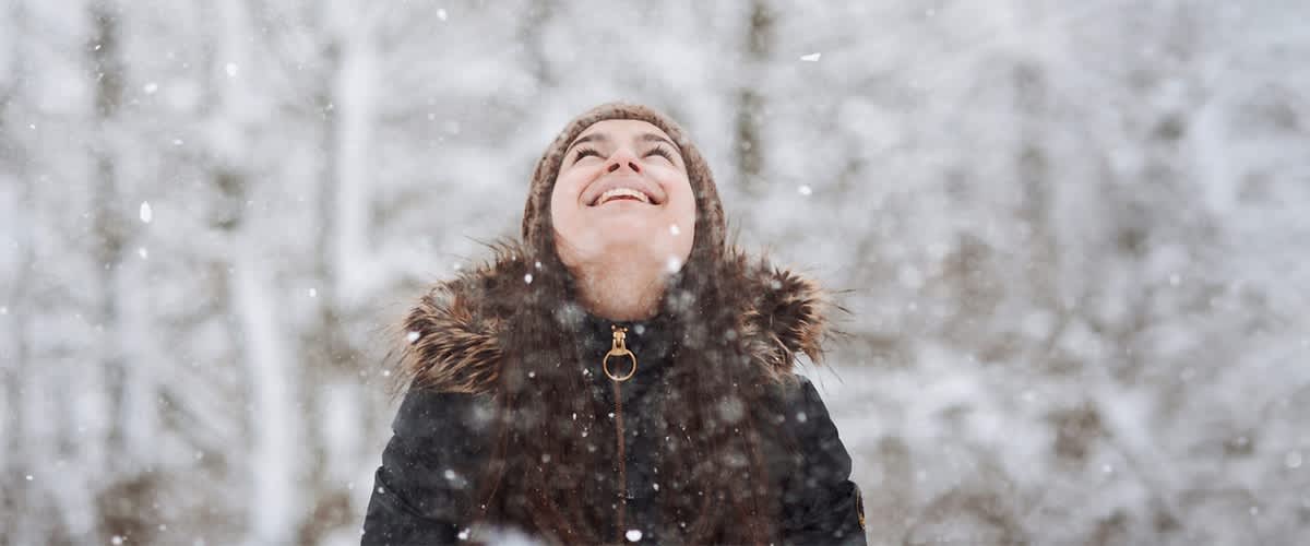 Frau lächelnd in Winterlandschaft