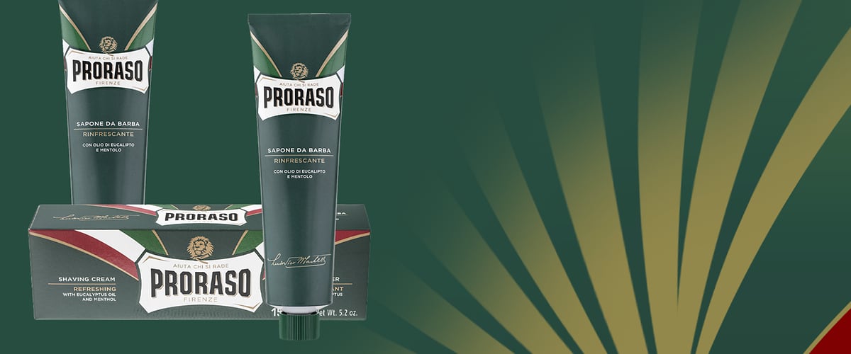 Tub și cutie de cremă de ras Proraso pe fundal verde și galben