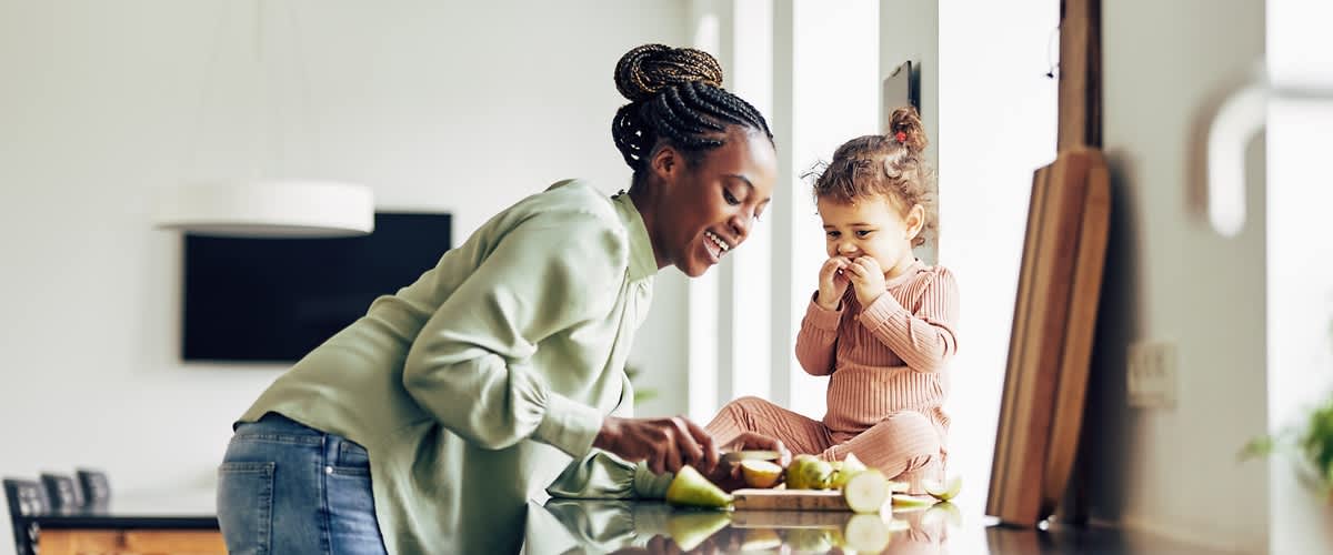Žena pripravujúca jedlo s malým dievčatkom