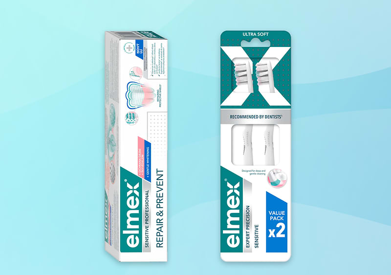 Elmex zubná pasta Repair & Prevent a balenie dvoch zubných kefiek na modrom pozadí