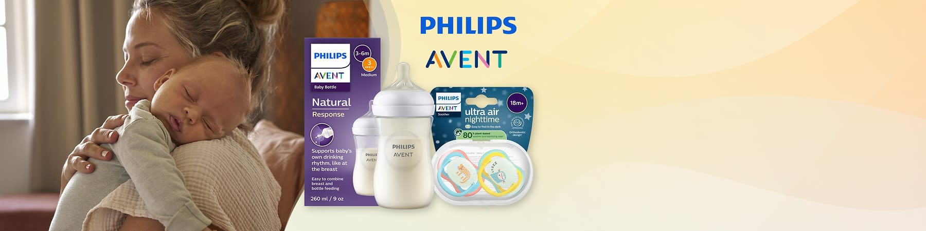 Matka drží spiace bábätko na chrbte a vedľa sú dojčenská fľaša a cumlíky značky Philips Avent