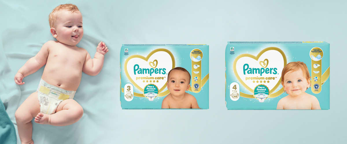 Dojenček na modri podlagi z dvema paketoma plenic Pampers premium care</br>