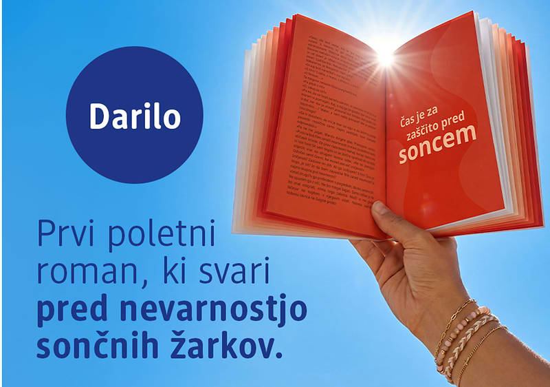 Darilo — odpri knjigo s soncem nad njo in roka z zapestnicamiKljučna beseda: sonce