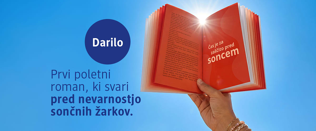 Darilo — odpri knjigo s soncem nad njo in roka z zapestnicamiKljučna beseda: sonce