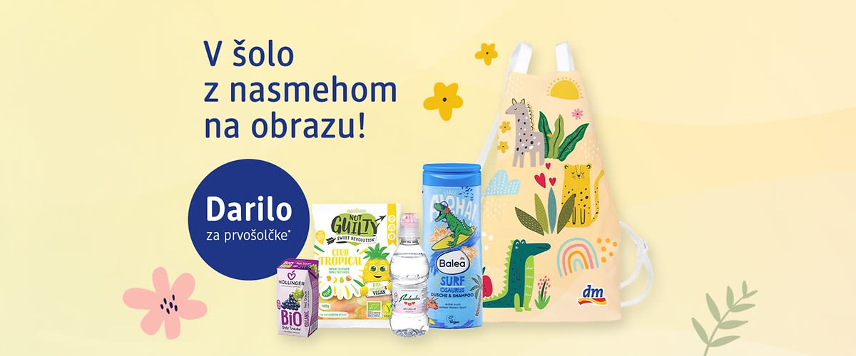 Darilo za prvošolčke s otroškim predpasnikom in različnimi pripomočki (pijača prigrizek šampon voda)
